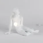 Table Lamp Innerglow Boy, shown on a bedside table