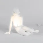 Table Lamp Innerglow Boy, shown on a bedside table