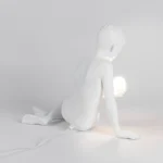 Table Lamp Innerglow Boy, shown on a bedside table