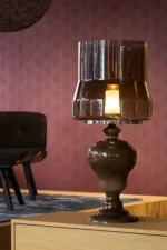 Glass table lamp illuminated, showing layered glow
