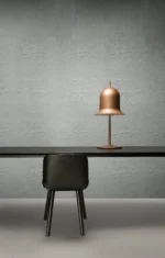 Bell shade lamp with shade tilted, in use