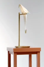Bird table lamp illuminated, angled view