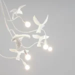 Ceiling Lamp Sparrow Flock, shown hanging over a dining table
