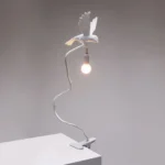 Table Lamp Sparrow with Clamp, shown clamped to a shelf