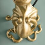 Table Lamp Octopus Gold, shown on a bedside table