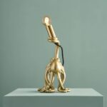 Table Lamp Octopus Gold, shown on a bedside table