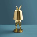 Table Lamp Rabbit LED Glossy Gold, shown illuminated on a bedside table