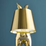 Table Lamp Rabbit LED Glossy Gold, shown illuminated on a bedside table