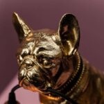 Table Lamp Bulldog Gold, shown on a sideboard