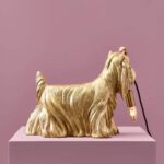 Table Lamp Dog Gold, shown on a sideboard