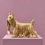 Table Lamp Dog Gold, shown on a sideboard