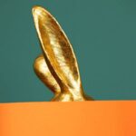 Table Lamp Rabbit Gold and Orange, shown in a living room setting