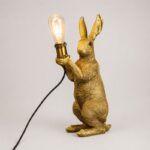 Table Lamp Rabbit Gold Meister, shown on a bedside table