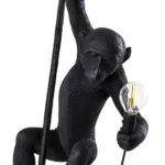 Ceiling Lamp Monkey Black, shown hanging in a living room