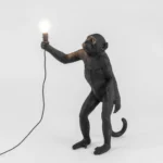 Table Lamp Monkey Standing Black, shown in a living room