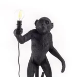 Table Lamp Monkey Standing Black, shown in a living room