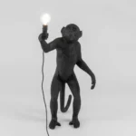 Table Lamp Monkey Standing Black, shown in a living room