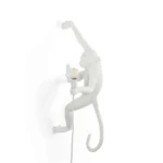 Wall Lamp Monkey Hanging White, shown mounted above a buffet