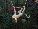 Ceiling Lamp Monkey Swing White, shown hanging in a living room