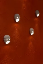 Ceramic wall sconce illuminated, angled view