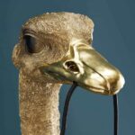 Wall Lamp Ostrich Gold Large, shown mounted in a living room