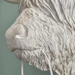 Wall Lamp Bison Gray, shown mounted in a living room