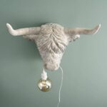 Wall Lamp Bison Gray, illuminated view showing the visible bulb