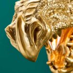 Wall Lamp Dragon Gold, shown mounted in a living room