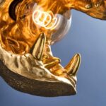 Wall Lamp Hippopotamus Gold, illuminated view showing the visible bulb