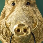 : Wall Lamp Wild Boar Gold, shown mounted in a living room