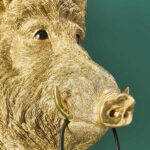 : Wall Lamp Wild Boar Gold, shown mounted in a living room