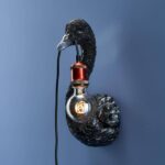 Wall Lamp Swan Black, shown mounted in a quiet corner