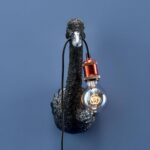Wall Lamp Swan Black, shown mounted in a quiet corner
