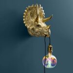 Wall Lamp Triceratops Gold, full front view of the dinosaur sculpture