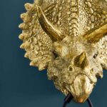Wall Lamp Triceratops Gold, full front view of the dinosaur sculpture