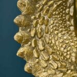 Wall Lamp Triceratops Gold, shown mounted in a living room