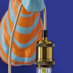 Wall Lamp Zebra Blue and Orange, illuminated view showing the visible bulb