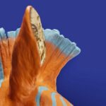Wall Lamp Zebra Blue and Orange, illuminated view showing the visible bulb